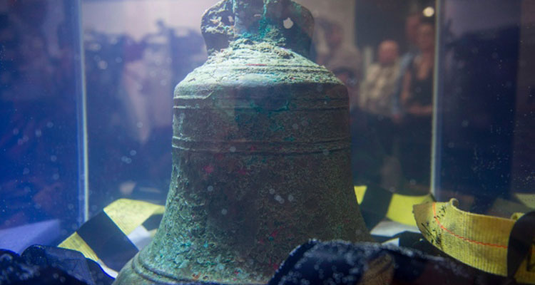 The ship's bell from the HMS Erebus sits in pure water in Ottawa following its recovery. Parks Canada is navigating competing claims for control and ownership of the Franklin artifacts. (Justin Tang/Canadian Press)
