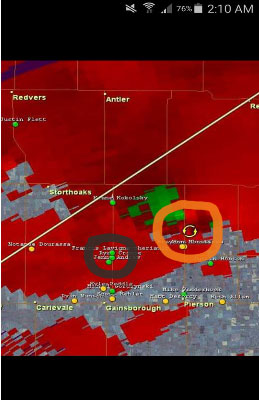 Radar Screen Shot Via Ryan Crouse. Shows our stopping position on the damage path (Black circle) and the circulating arrows show the area of rotation (Tornado) (orange circle)